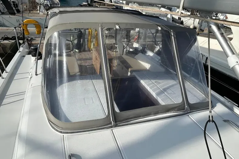  Yacht Photos Pics 2024 Beneteau First 44 sailboat with cockpit enclosure, docked at marina.