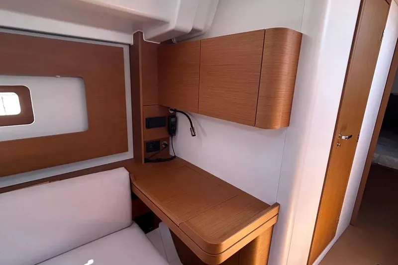  Yacht Photos Pics Interior of 2024 Beneteau First 44 yacht, featuring a sleek wooden desk and modern design.