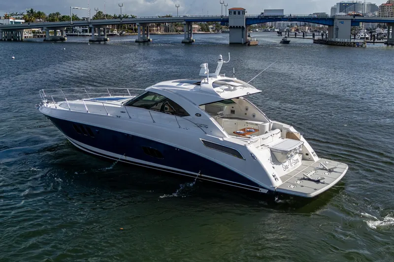 Sea N Starrs Yacht Photos Pics 2012 Sea Ray 540 Sundancer yacht cruising near a bridge on a sunny day.