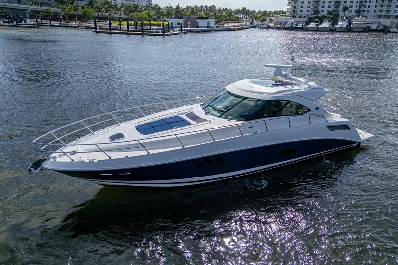 Sea N Starrs Yacht Photos Pics 2012 Sea Ray 540 Sundancer yacht cruising on a sunny day in a marina.