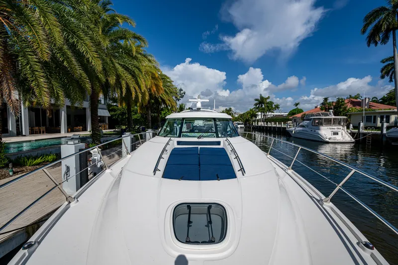 Sea N Starrs Yacht Photos Pics 2012 Sea Ray 540 Sundancer yacht docked by palm trees under a blue sky.