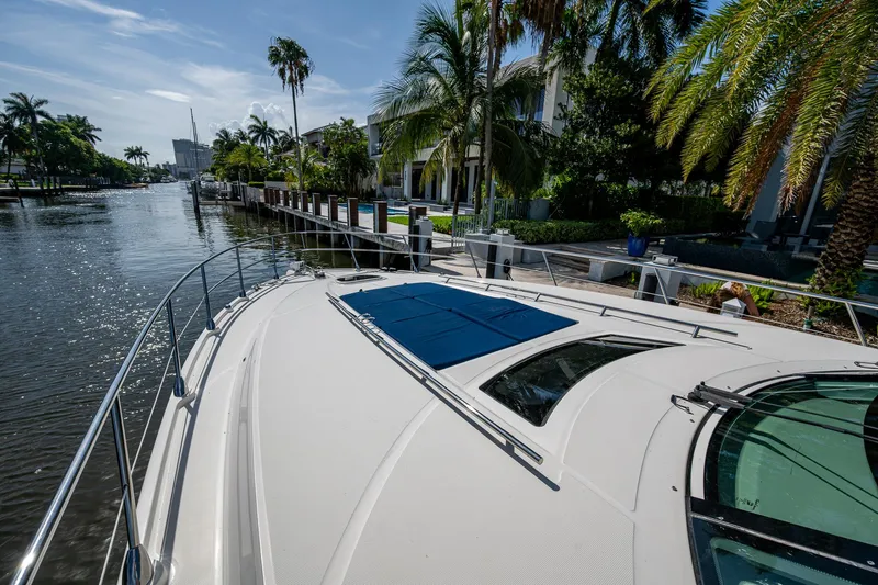 Sea N Starrs Yacht Photos Pics 2012 Sea Ray 540 Sundancer yacht docked by palm trees and waterfront homes.