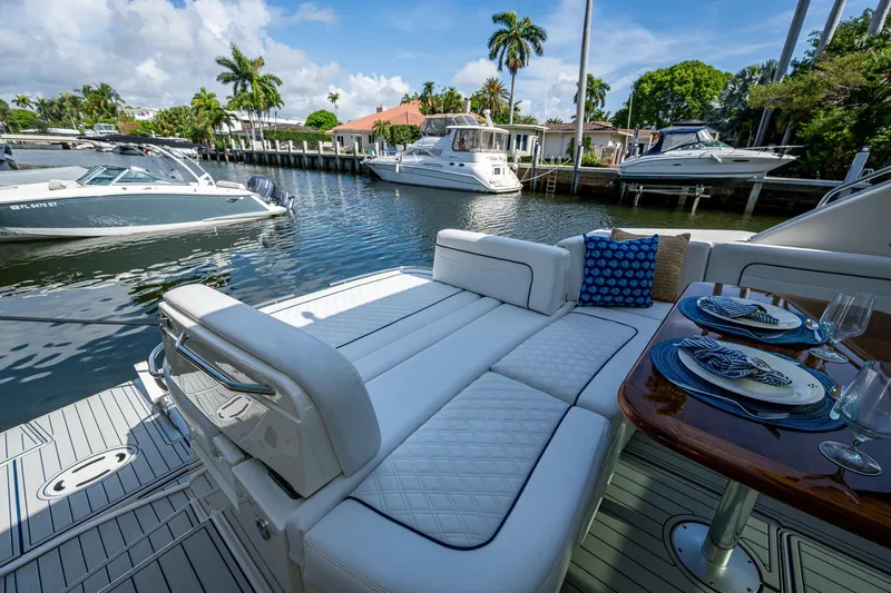 Sea N Starrs Yacht Photos Pics Luxurious 2012 Sea Ray 540 Sundancer yacht with elegant seating and dining area, docked in a scenic marina.