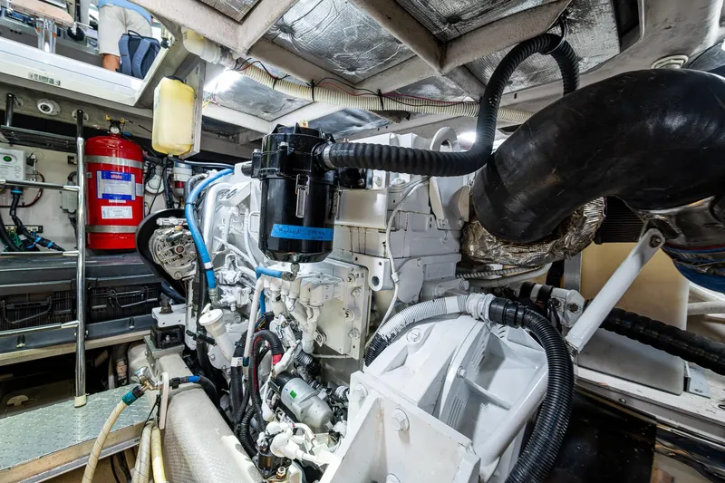 Sea N Starrs Yacht Photos Pics Engine room of 2012 Sea Ray 540 Sundancer yacht, showcasing mechanical components and fire extinguisher.