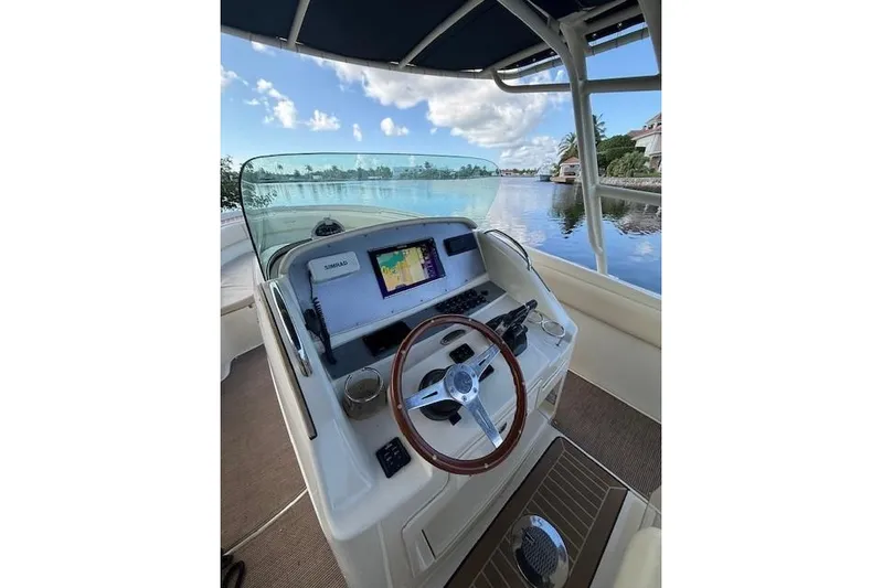  Yacht Photos Pics 2015 Chris-Craft Catalina 29 helm with navigation system, steering wheel, and waterfront view.