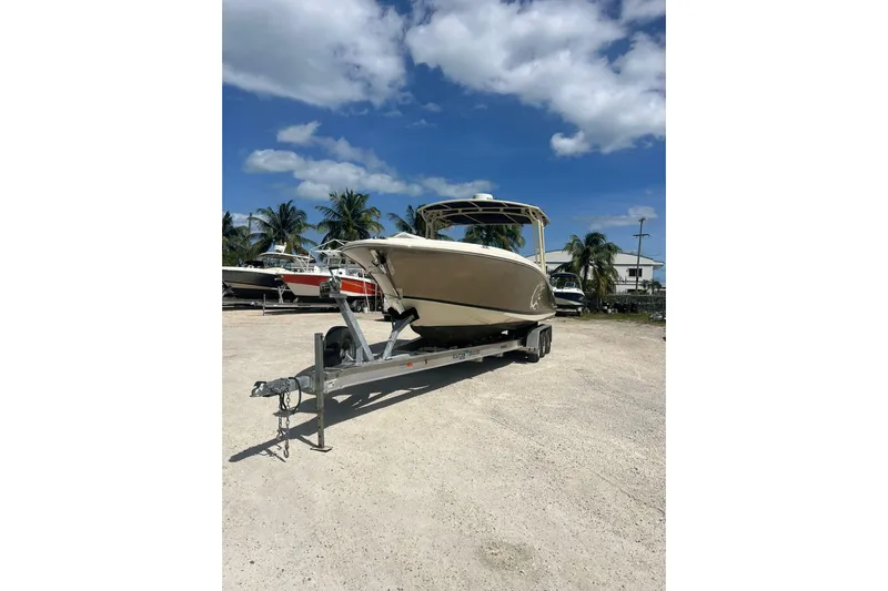  Yacht Photos Pics 2015 Chris-Craft Catalina 29 boat on trailer under blue sky with palm trees.