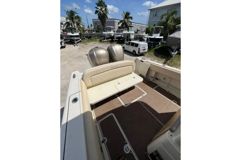  Yacht Photos Pics 2015 Chris-Craft Catalina 29 boat interior with seating and twin engines, parked outdoors.