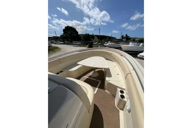  Yacht Photos Pics 2015 Chris-Craft Catalina 29 boat interior with seating and table under a clear sky.