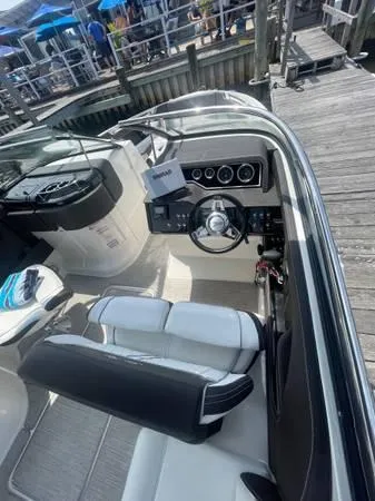  Yacht Photos Pics 2017 Sea Ray SLX 280 boat interior with steering wheel and dock in background.