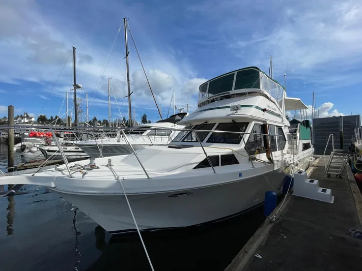 Safe N Sound Yacht Photos Pics 1988 Canoe Cove Tri Cabin yacht docked at marina under blue sky.