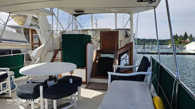 Safe N Sound Yacht Photos Pics 1988 Canoe Cove Tri Cabin yacht interior with seating area and table, docked at marina.