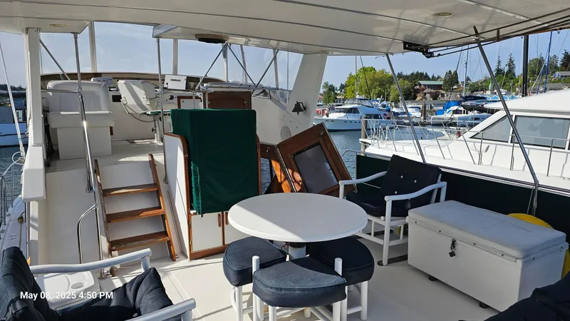 Safe N Sound Yacht Photos Pics 1988 Canoe Cove Tri Cabin yacht with outdoor seating and marina view.