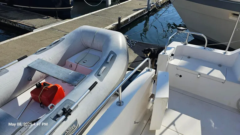 Safe N Sound Yacht Photos Pics 1988 Canoe Cove Tri Cabin with inflatable dinghy docked at marina.