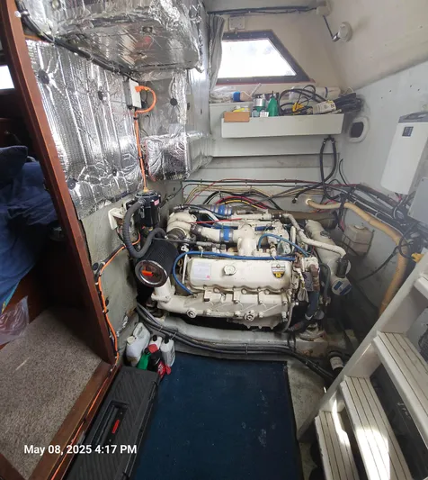 Safe N Sound Yacht Photos Pics Engine room of a 1988 Canoe Cove Tri Cabin boat, showcasing mechanical components and wiring.