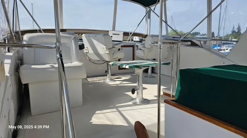 Safe N Sound Yacht Photos Pics 1988 Canoe Cove Tri Cabin yacht interior with seating and table, docked at marina.