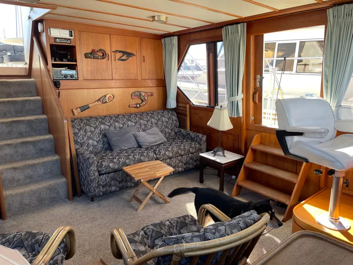 Safe N Sound Yacht Photos Pics Interior of 1988 Canoe Cove Tri Cabin with cozy seating and nautical decor.