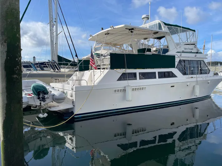 Safe N Sound Yacht Photos Pics 1988 Canoe Cove Tri Cabin yacht docked at marina, reflecting on calm water.