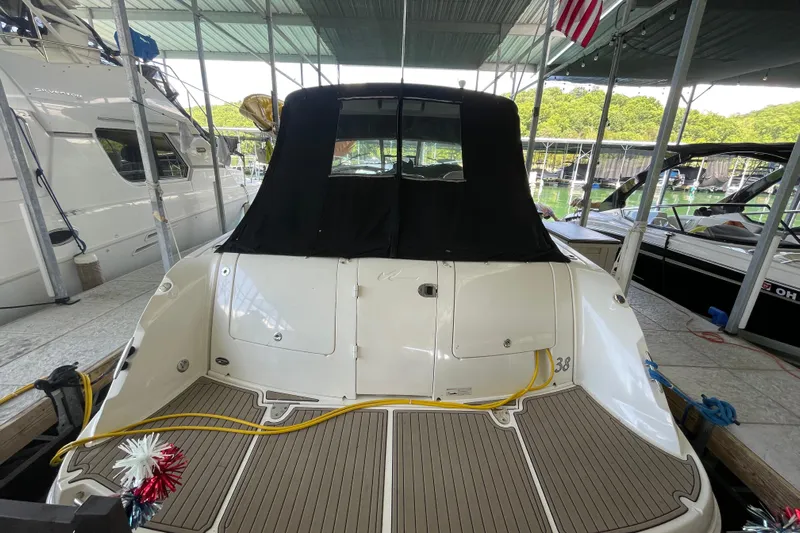  Yacht Photos Pics 2007 Sea Ray 38 Sundancer docked, rear view with covered cockpit and American flag.
