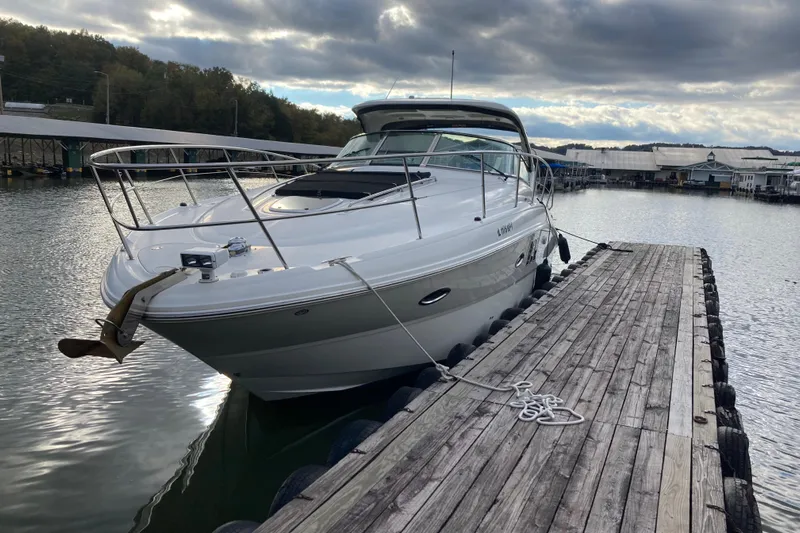  Yacht Photos Pics 2007 Sea Ray 38 Sundancer yacht docked at a wooden pier under cloudy skies.