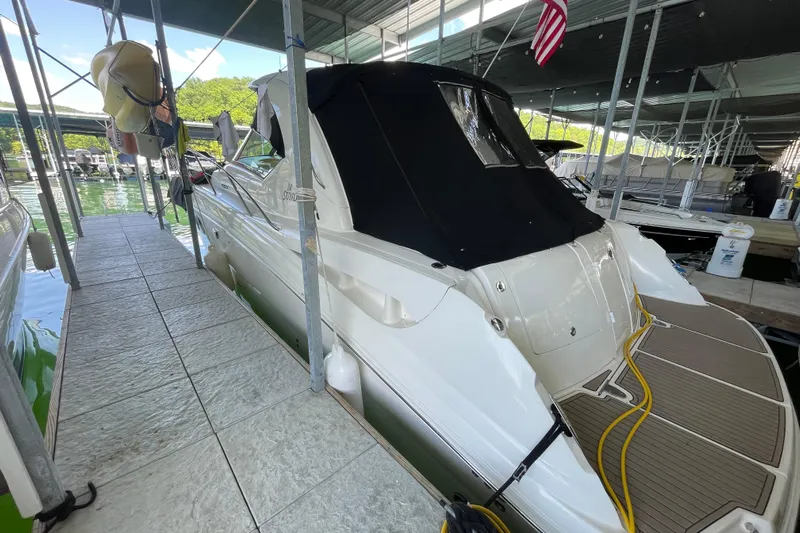  Yacht Photos Pics 2007 Sea Ray 38 Sundancer docked in a marina, covered with a black canopy.