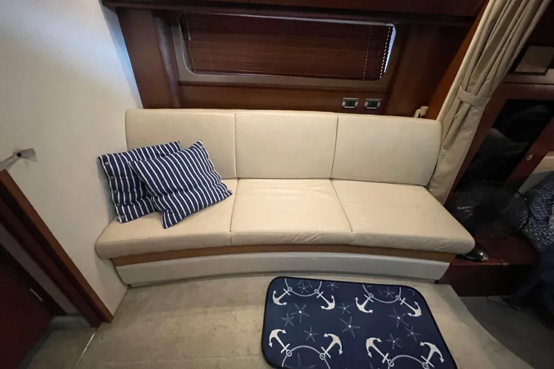  Yacht Photos Pics Interior of 2007 Sea Ray 38 Sundancer with beige sofa and nautical-themed decor.