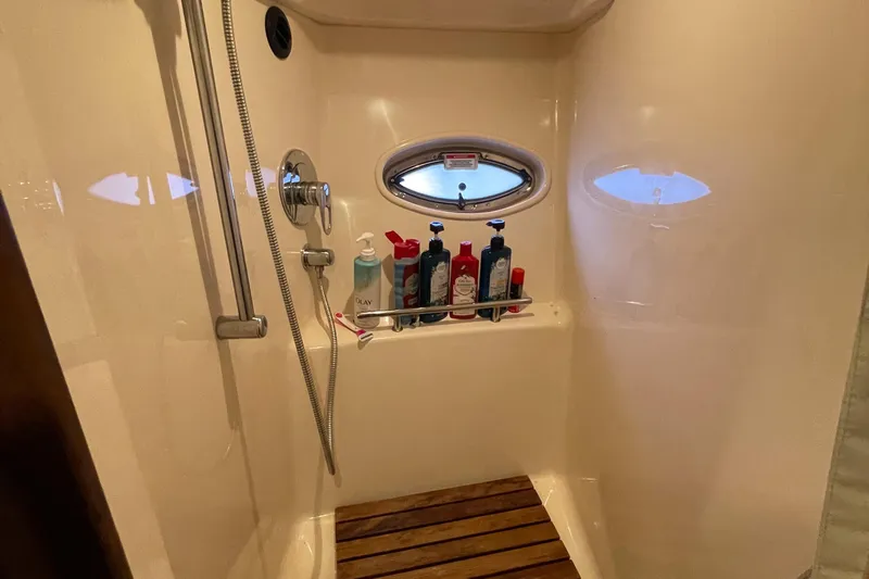  Yacht Photos Pics Shower area in 2007 Sea Ray 38 Sundancer yacht with toiletries and porthole window.