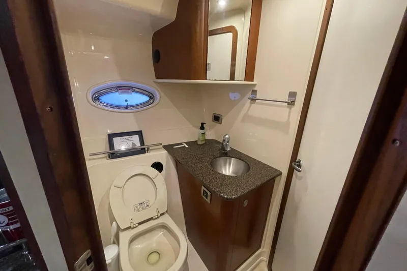  Yacht Photos Pics 2007 Sea Ray 38 Sundancer bathroom with sink, toilet, and porthole window.