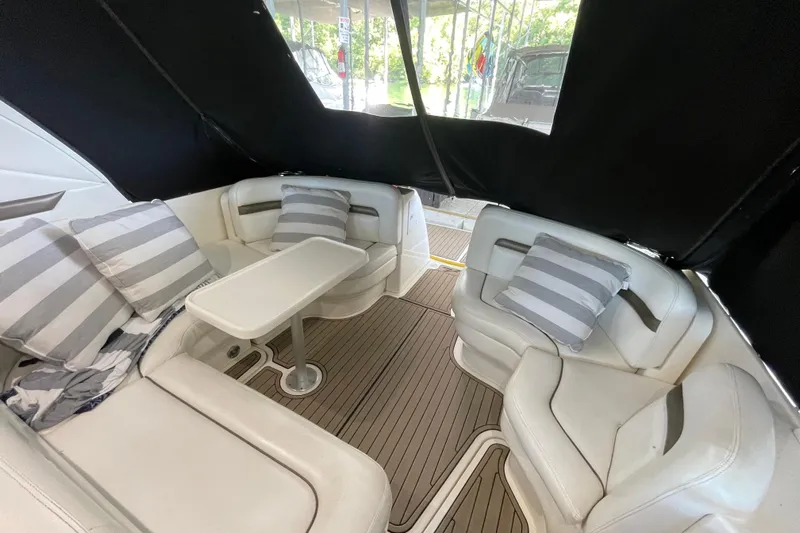  Yacht Photos Pics Luxurious 2007 Sea Ray 38 Sundancer interior with white seating and striped cushions.