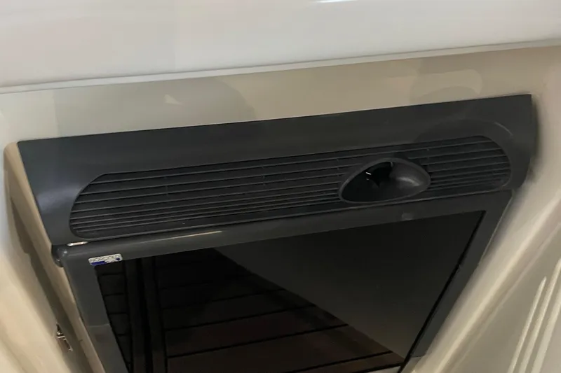  Yacht Photos Pics 2007 Sea Ray 38 Sundancer cabin interior with black vent and storage compartment.