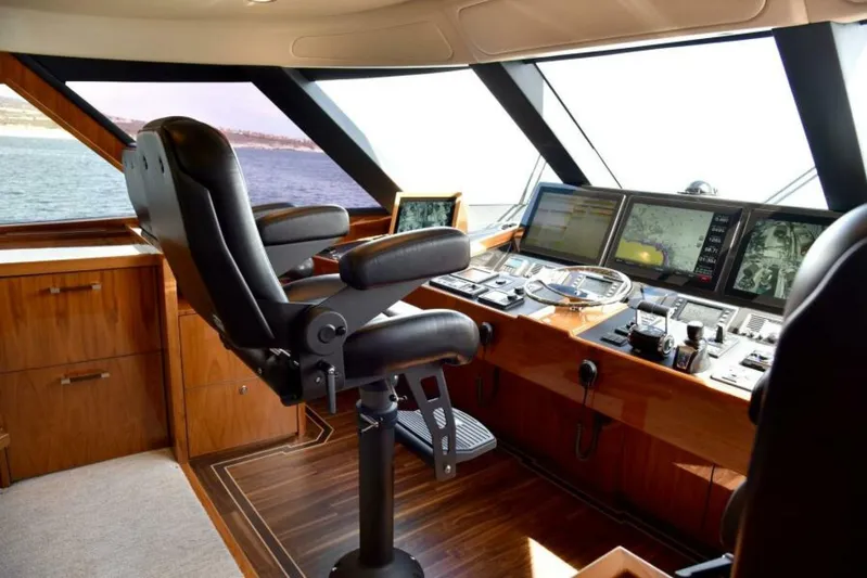 Another Day In Paradise Yacht Photos Pics Luxurious helm of 2017 Viking 80 Sky Bridge yacht with advanced navigation systems.