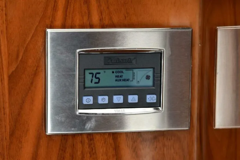 Another Day In Paradise Yacht Photos Pics Thermostat on 2017 Viking 80 Sky Bridge yacht, displaying 75 degrees on wood panel.