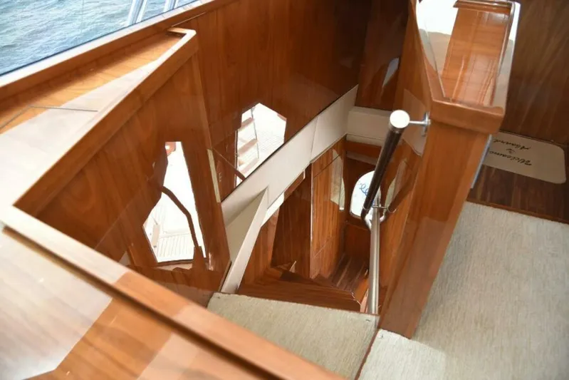 Another Day In Paradise Yacht Photos Pics Luxurious wooden staircase on 2017 Viking 80 Sky Bridge yacht interior.