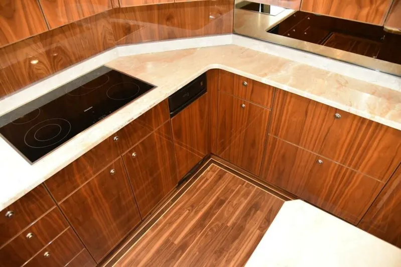 Another Day In Paradise Yacht Photos Pics Luxurious wooden kitchen interior of 2017 Viking 80 Sky Bridge yacht.