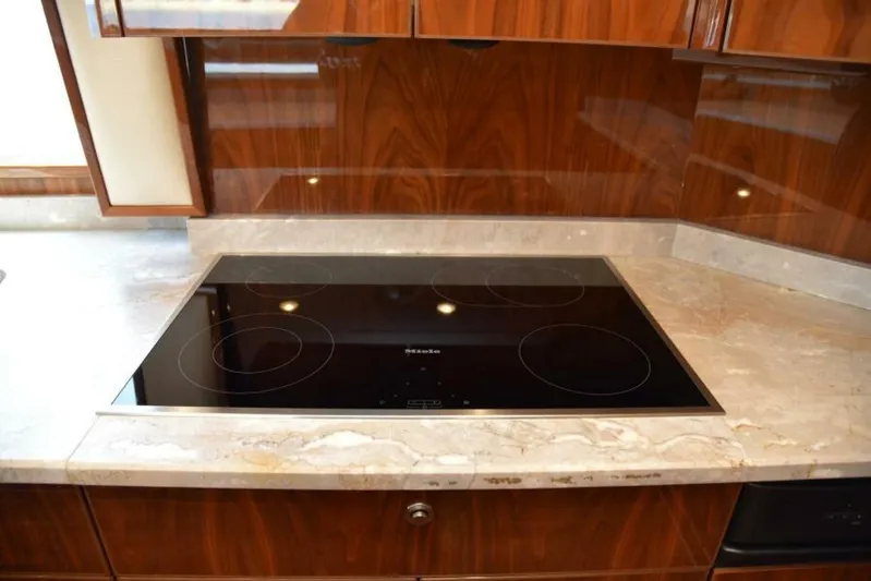 Another Day In Paradise Yacht Photos Pics Modern kitchen with sleek cooktop on Viking 80 Sky Bridge yacht, 2017 model.