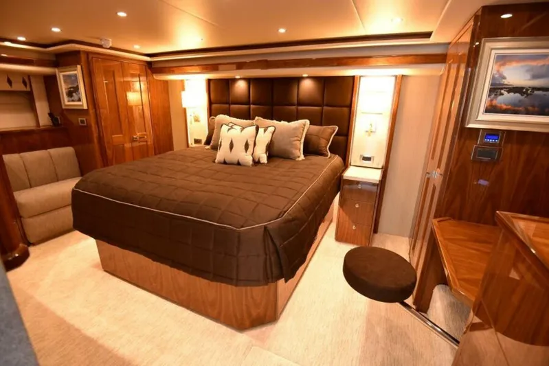 Another Day In Paradise Yacht Photos Pics Luxurious bedroom interior of 2017 Viking 80 Sky Bridge yacht with elegant wood finishes.