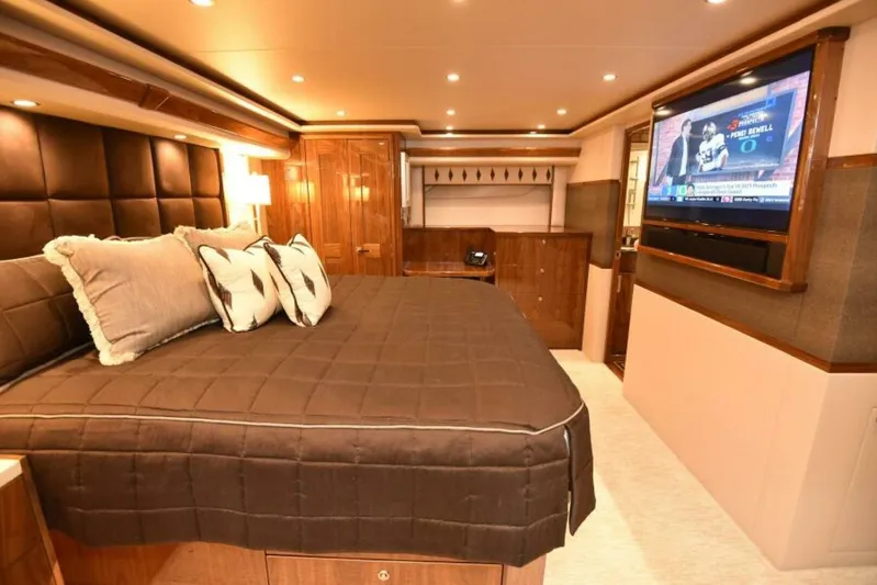 Another Day In Paradise Yacht Photos Pics Luxurious bedroom interior of 2017 Viking 80 Sky Bridge yacht with TV and elegant decor.