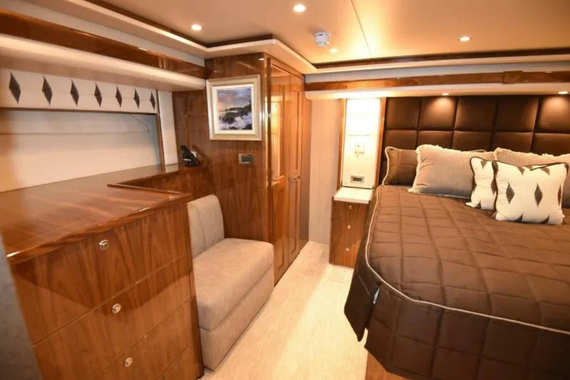 Another Day In Paradise Yacht Photos Pics Luxurious bedroom interior of 2017 Viking 80 Sky Bridge yacht with elegant wood finishes.