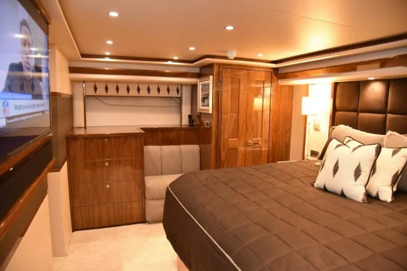 Another Day In Paradise Yacht Photos Pics Luxurious bedroom interior of 2017 Viking 80 Sky Bridge yacht with elegant wood finishes.