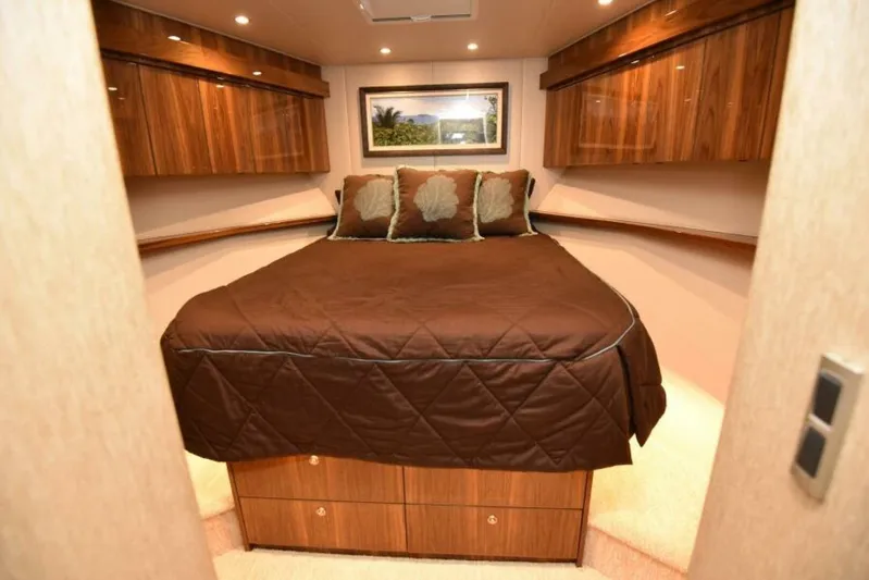 Another Day In Paradise Yacht Photos Pics Luxurious bedroom interior of 2017 Viking 80 Sky Bridge yacht with wood cabinetry.