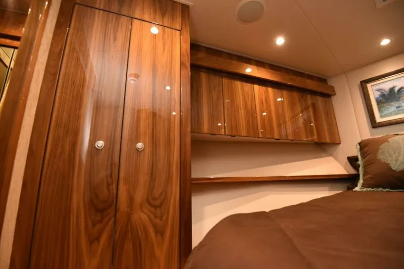 Another Day In Paradise Yacht Photos Pics Luxurious wood interior of 2017 Viking 80 Sky Bridge yacht cabin.