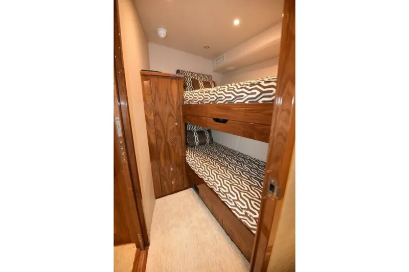 Another Day In Paradise Yacht Photos Pics Bunk beds in 2017 Viking 80 Sky Bridge yacht cabin with patterned bedding.