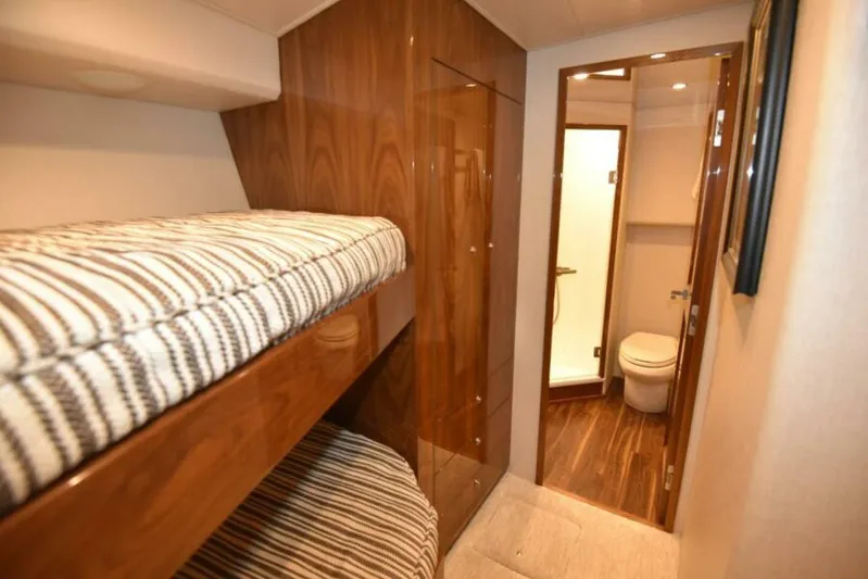 Another Day In Paradise Yacht Photos Pics 2017 Viking 80 Sky Bridge interior with bunk beds and bathroom.
