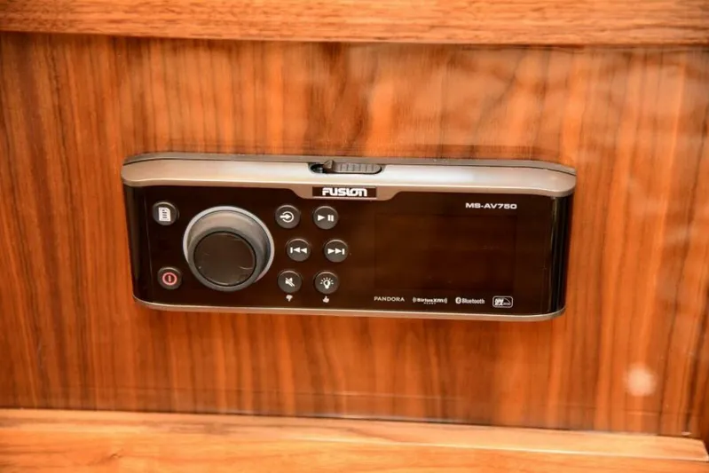 Another Day In Paradise Yacht Photos Pics Fusion MS-AV750 audio system on 2017 Viking 80 Sky Bridge yacht, mounted on wood panel.