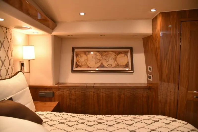 Another Day In Paradise Yacht Photos Pics Luxurious 2017 Viking 80 Sky Bridge yacht interior with elegant wood paneling and world map decor.