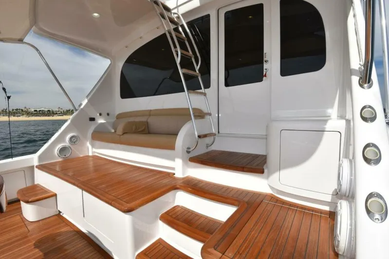 Another Day In Paradise Yacht Photos Pics Luxurious 2017 Viking 80 Sky Bridge yacht with elegant wooden deck and seating area.