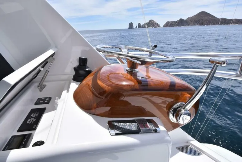 Another Day In Paradise Yacht Photos Pics 2017 Viking 80 Sky Bridge yacht helm with ocean view and distant rocky islands.