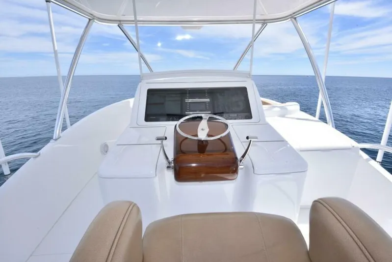 Another Day In Paradise Yacht Photos Pics 2017 Viking 80 Sky Bridge yacht helm with ocean view and modern controls.