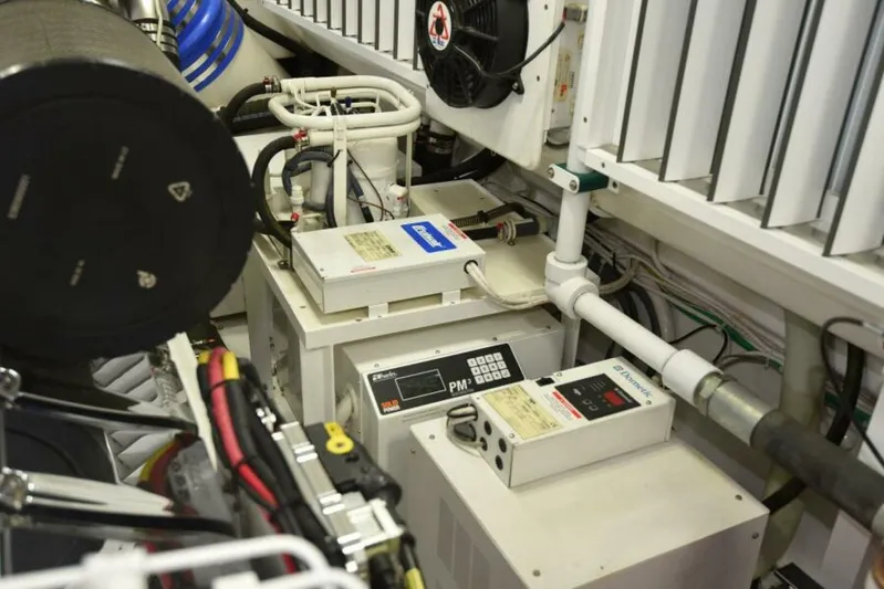 Another Day In Paradise Yacht Photos Pics Engine room of 2017 Viking 80 Sky Bridge yacht, showcasing mechanical components and wiring.