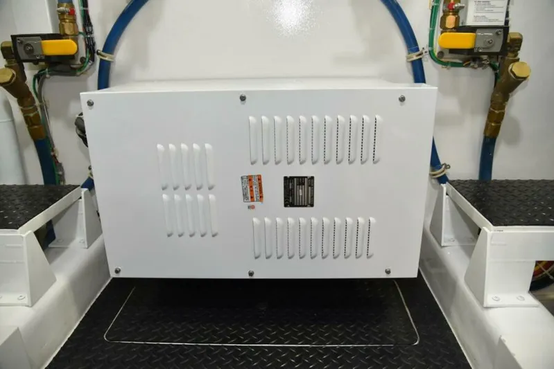 Another Day In Paradise Yacht Photos Pics Engine room of 2017 Viking 80 Sky Bridge yacht, featuring equipment and piping.