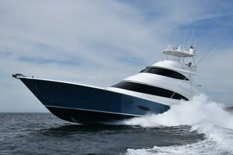 Another Day In Paradise Yacht Photos Pics 2017 Viking 80 Sky Bridge yacht cruising on open water, creating waves.